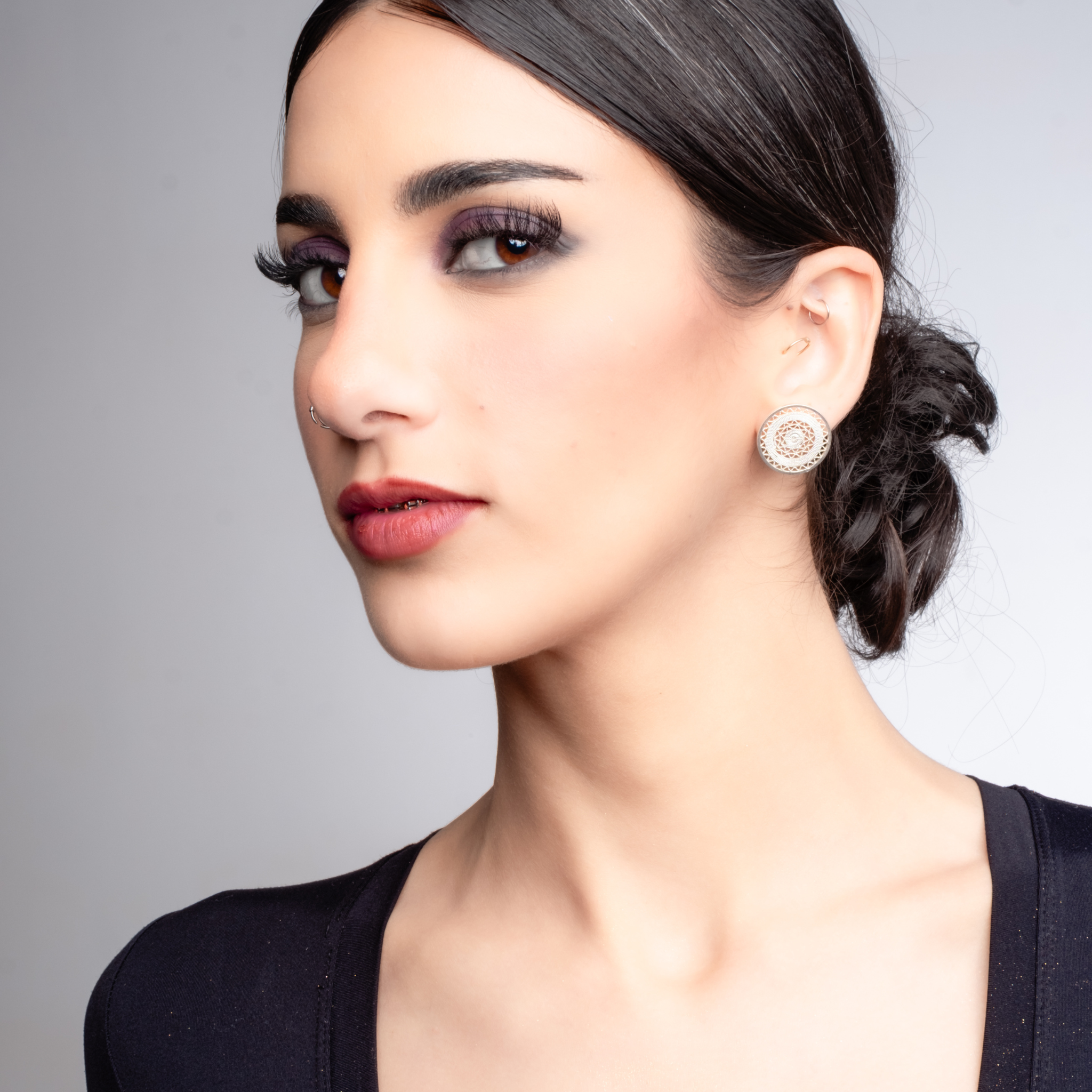 Woman wearing Sol, custom made MorphEar stud filigree earrings by Valerosa