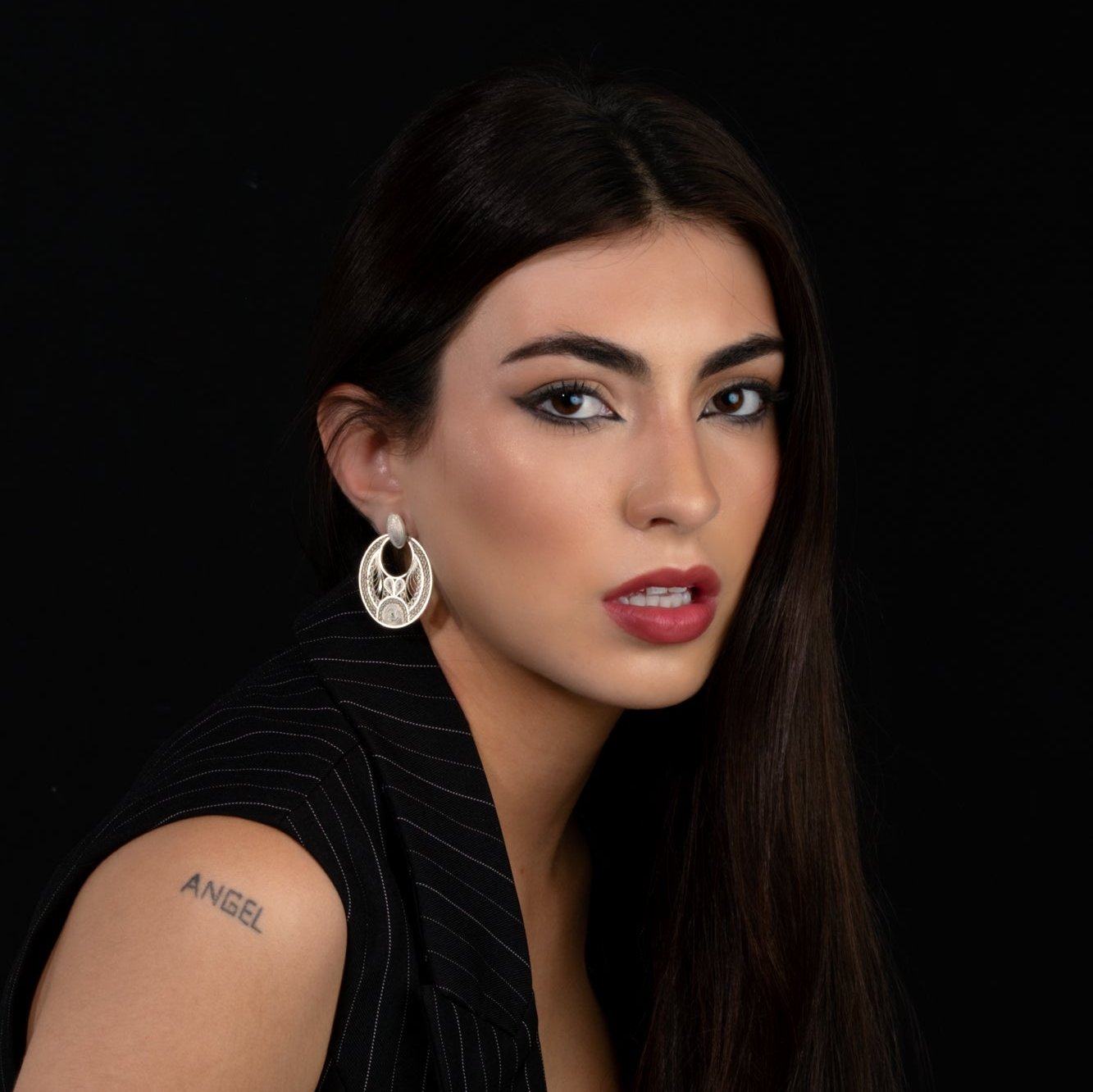 Woman wearing silver filigree MorphEar statement earrings by Valerosa