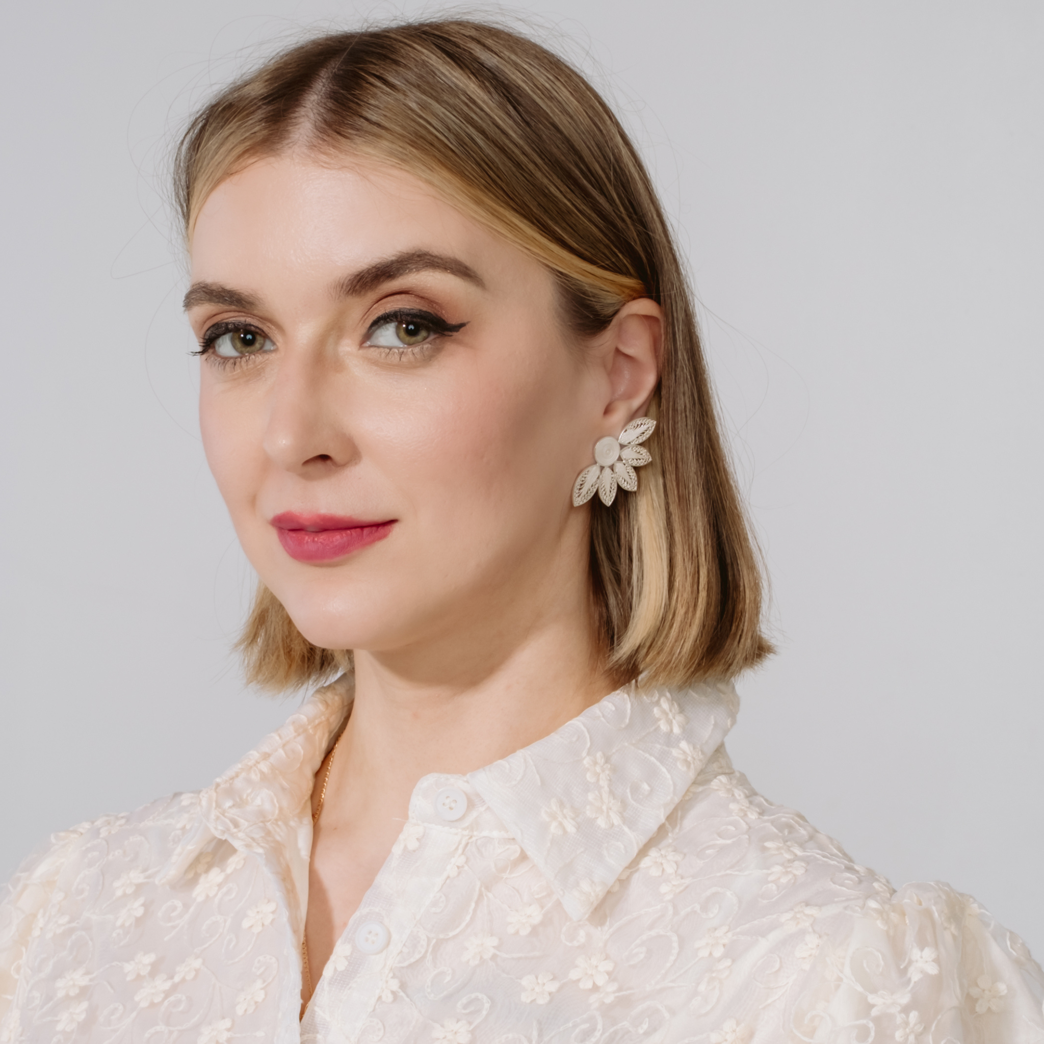 Woman wearing Candelaria, silver filigree earrings by Valerosa