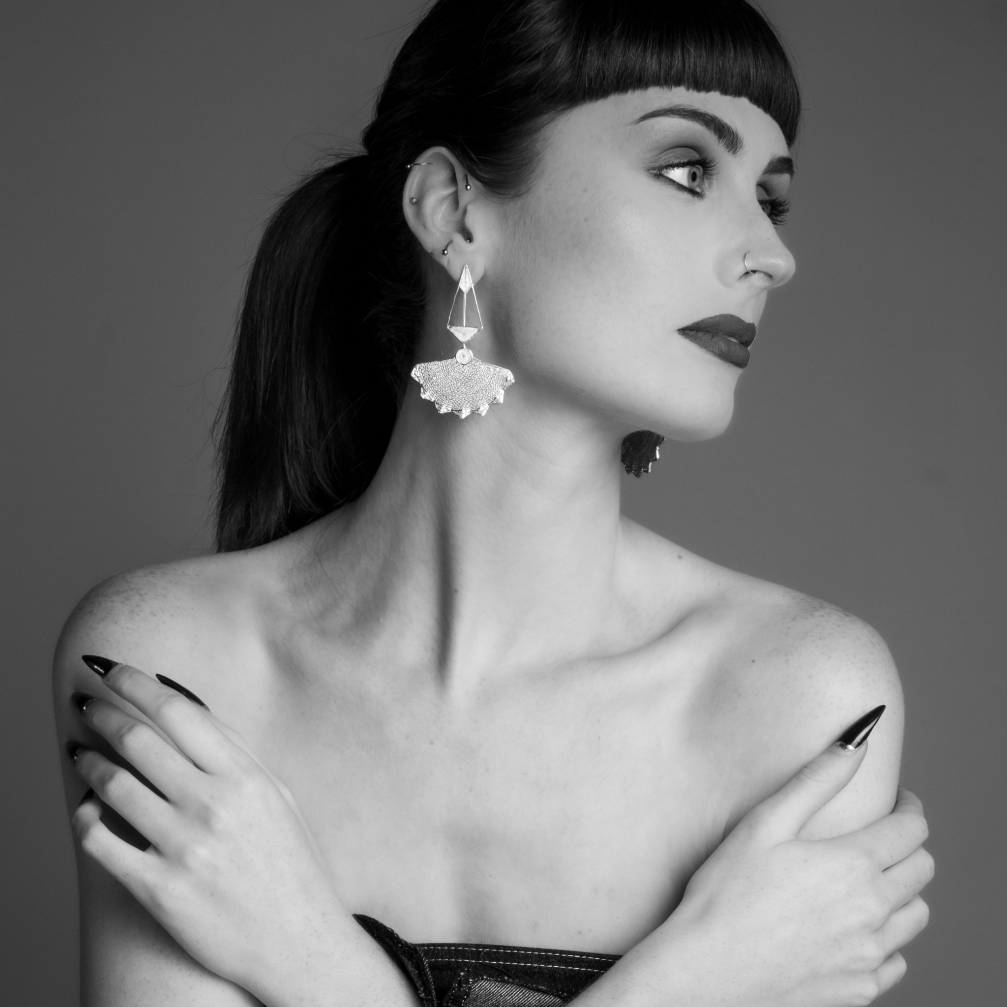 Woman wearing Virtudes, handmade silver filigree convertible earrings by Valerosa
