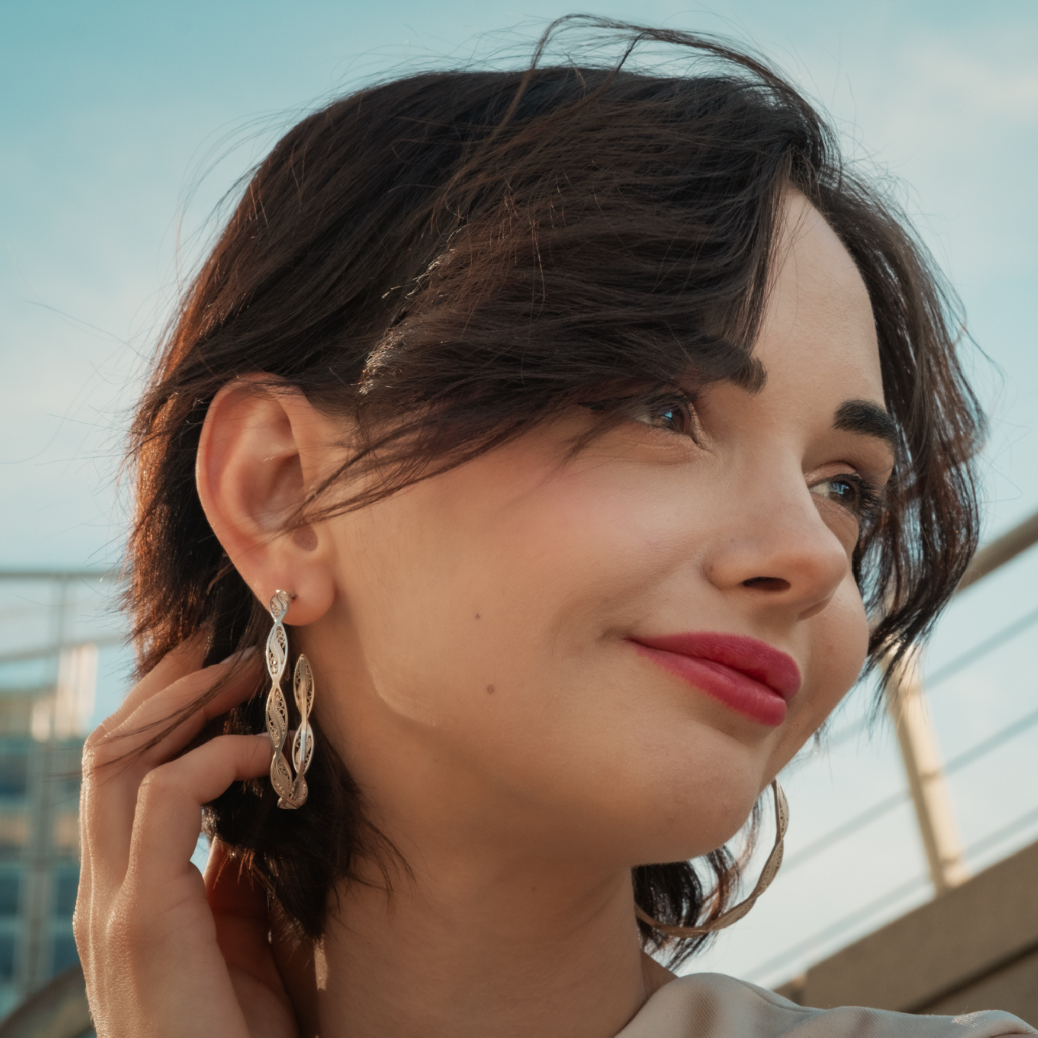 Woman wearing Macarena, handmade silver filigree hoop 