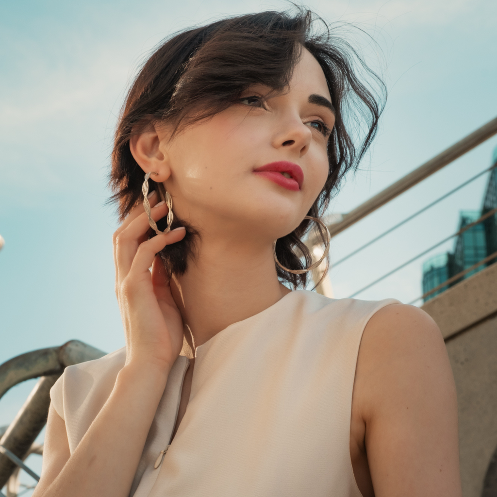 Woman wearing Macarena, handmade silver filigree hoop 