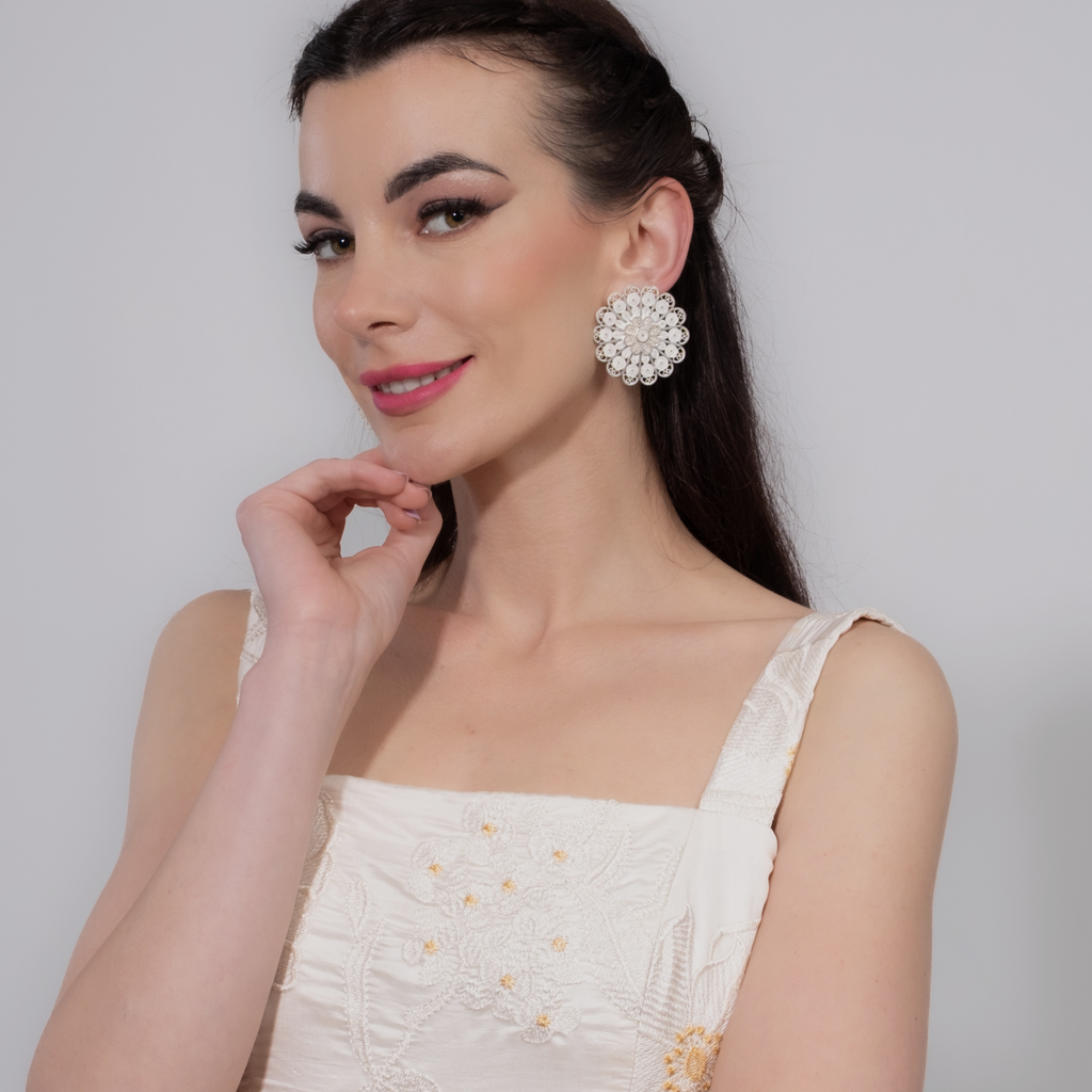 Woman wearing Soledad, handmade silver filigree statement earrings 
