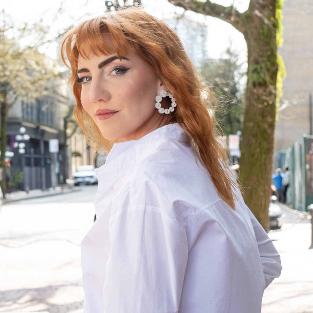 Woman wearing Estela, silver filigree hoop earrings by Valerosa.