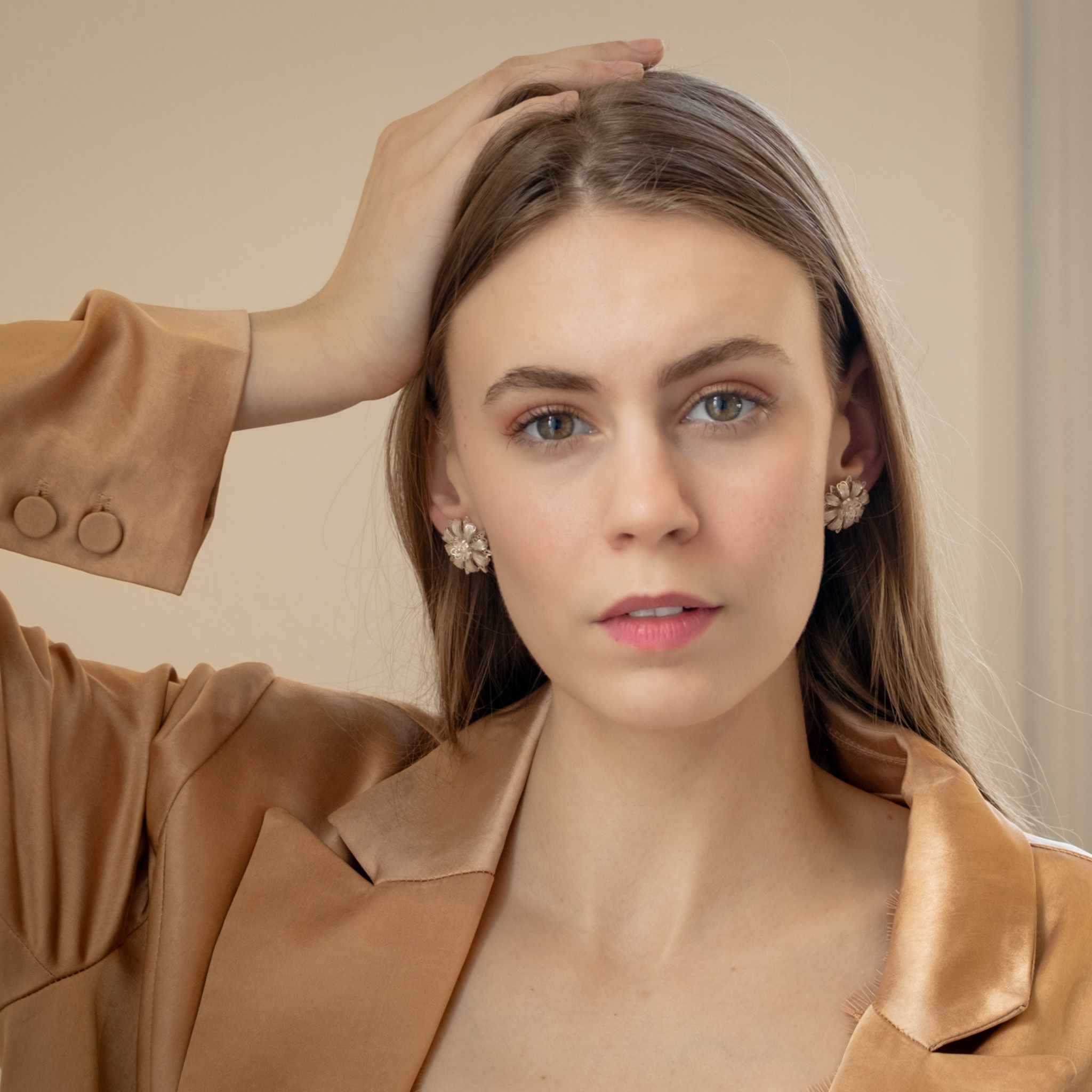 Woman wearing Milagros, handmade silver filigree convertible earrings by Valerosa 
