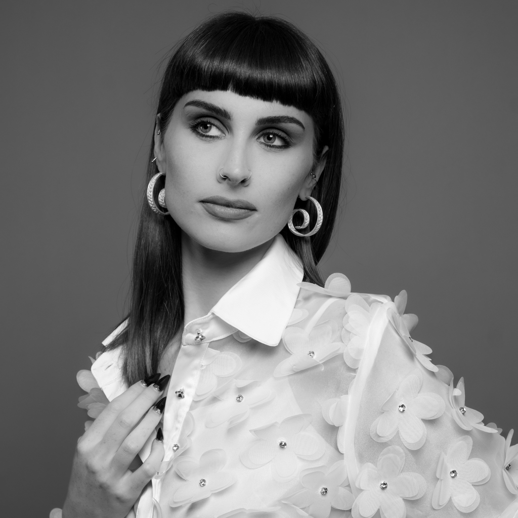 Woman wearing Casta, handmade silver filigree hoop earrings by Valerosa