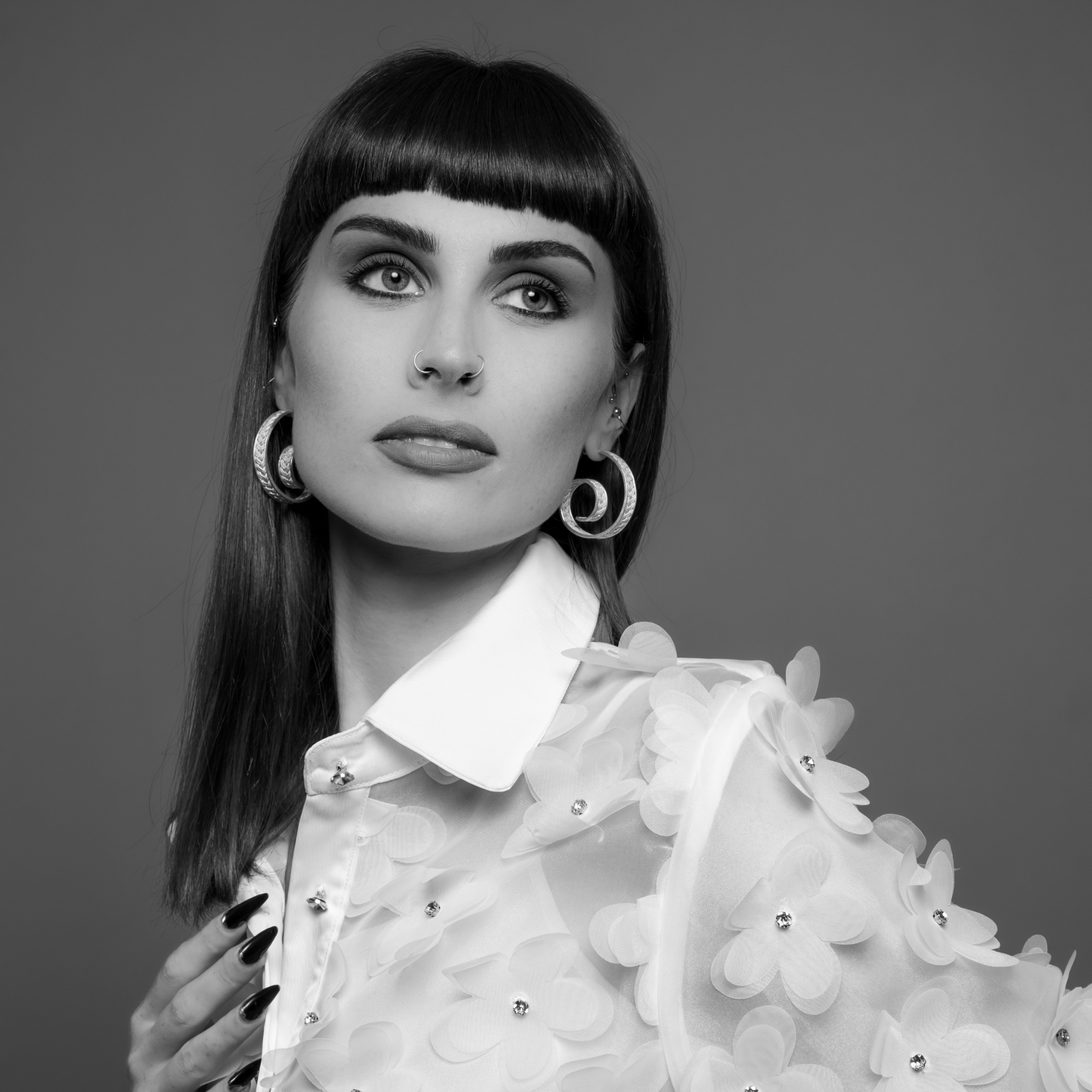 Woman wearing Casta, custom made silver filigree hoop earrings by Valerosa